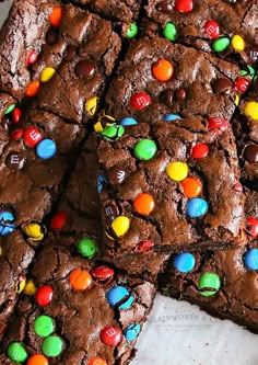 chocolate brownies with m & m candies on top and one cut in half