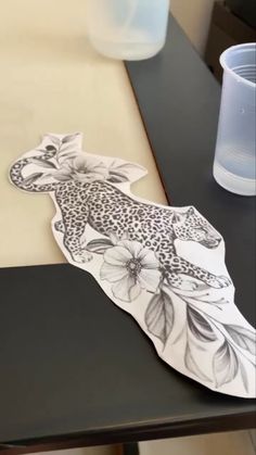 a paper cut out of a giraffe sitting on top of a black table