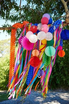 the instagram page is full of colorful paper lanterns and streamers hanging from trees