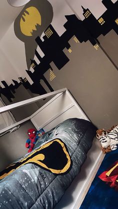 a child's bedroom with batman themed bedding