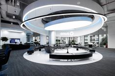 an office lobby with round seating and circular lights