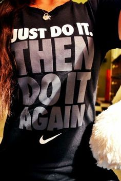 a woman is holding a teddy bear and wearing a t - shirt that says, just do it then do it again