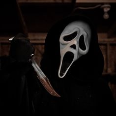 a person wearing a mask and holding a knife