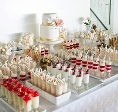 a table topped with lots of cakes and desserts