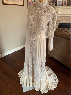 an antique dress is on display in the living room