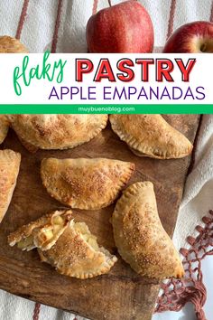 baked apple empanadas on a wooden cutting board with apples in the background