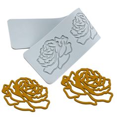 two cookie cutters, one with a rose on it and the other with a flower