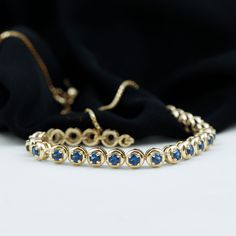 Product Details This Tennis Chain Bracelet is perfectly decorated with round shape Created Blue Sapphire in a semi eternity style in a Prong Setting. This Rope Chain Bracelet will magnify the beauty of your wrist and make your wrist glossy. Product Information SKU SHP-BRACELET0621104297 Length 177.8 mm Width 3.8 mm Height 3.2 mm Weight 6.56 gm (Approximate) LAB CREATED BLUE SAPPHIRE INFORMATION No.of Stones 23 Pieces Total Weight 3.45 Carat (Approximate) Dimension(approx) Round-3X3 mm-23 Pcs Col Fine Jewelry Blue Diamond Cut Bracelets, Fine Jewelry Blue Diamond Cut Bracelet, Blue Diamond Bracelet With Prong Setting For Anniversary, Flexible Yellow Gold Tennis Bracelet, Flexible 14k Gold Tennis Bracelet, Yellow Gold Birthstone Chain Bracelet, Blue Birthstone Bracelets In Fine Jewelry Style, Fine Blue Diamond Cut Bracelet, Sapphire Jubilee Bracelet