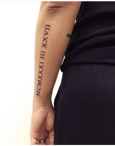 a person with a tattoo on their arm that reads, i am xxxix