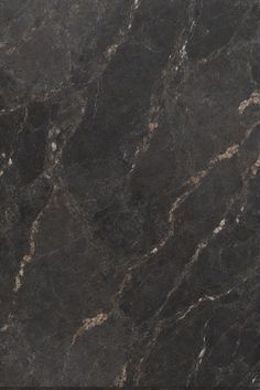 a black marble counter top with white and gold veining