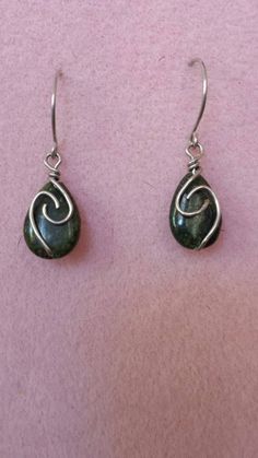 These 10*15mm teardrop jade stones are wrapped in antique silver wire. They hang about 1 1/4" in length.  $14 #S036  JewelryArtByLinda@gmail.com Silver Teardrop Wrap Earrings, Turquoise Wire Wrapped Teardrop Earrings, Turquoise Teardrop Earrings Wire Wrapped, Teardrop Wire Wrapped Earrings, Nickel-free Teardrop Jade Earrings, Nickel-free Teardrop Jade Jewelry, Sterling Silver Teardrop Earrings With Natural Stones, Handmade Teardrop Jade Jewelry, Green Wire Wrapped Teardrop Jewelry