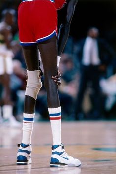 a basketball player in red jersey and white socks