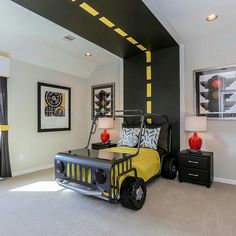 a bedroom with black and yellow decor, white walls, and carpeted flooring