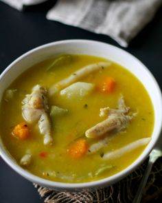 a white bowl filled with soup on top of a table