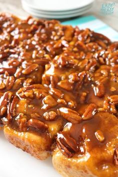 pecan pie with caramel sauce on a white plate