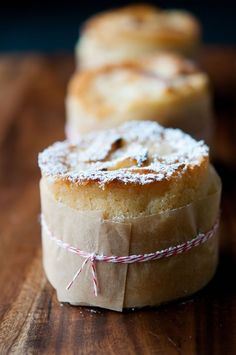 three pastries sitting on top of a wooden cutting board