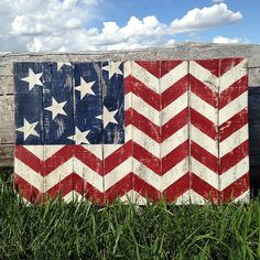 an american flag painted on a wooden fence