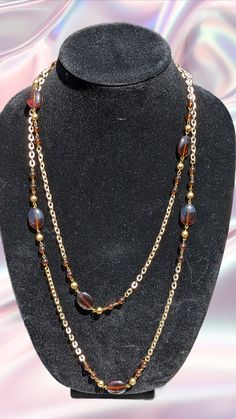 Vintage beaded opera necklace. In great condition. Measures 27" long There are 2 small clear brown beads then a small gold bead proceeding a large clear brown oval bead and then gold and 2 brown . This repeats 7 times Opera Necklace, Necklace With Beads, Wedding Jewellery Necklace, Gold Tone Necklace, Wedding Necklace, Gold Beads, Wedding Jewelry, Opera, Gold Tones