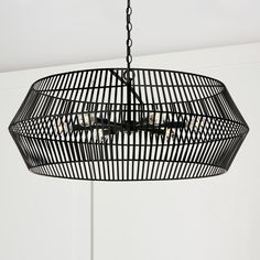 a black chandelier hanging from a ceiling with five lights in the shape of a cage