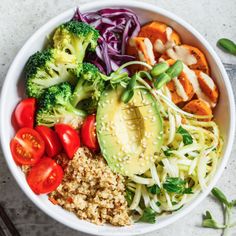 a white bowl filled with vegetables and rice