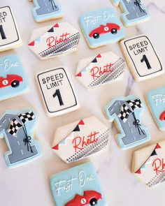 decorated cookies with cars and numbers on them for a first birthday party or baby shower