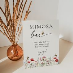 a card that says mimosa bar on it next to a vase with flowers