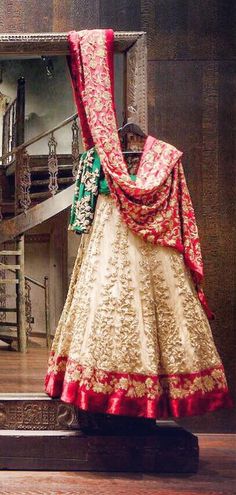 a bride's dress is displayed in front of a mirror