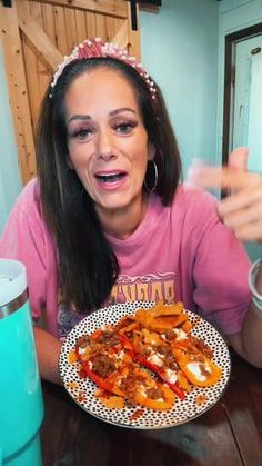 a woman sitting at a table with a plate of food