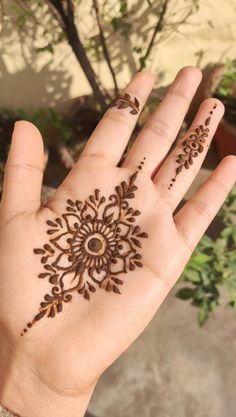 a person's hand with henna tattoos on it