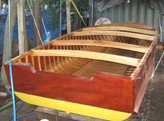 a wooden boat being built in a yard