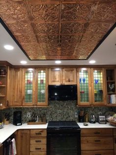 a kitchen with wooden cabinets and an intricate ceiling