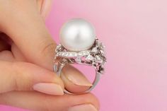 For Sale on 1stDibs - This South Sea pearl and diamond cocktail ring features a gem quality pearl of pinkish hues and 17.5mm diameter. The pearl is untreated. It displays a Elegant White Ring For Evening Occasions, Elegant White Ring For Evening, Elegant White Evening Ring, Elegant Wedding Rings With Pearl Pendant, Luxury Pearl White Pearl Ring For Wedding, Exquisite Pearl Ring With Diamond Accents, Luxury Pearl Wedding Ring, Luxury Pearl Wedding Ring With Gemstone, Luxury Pearl Gemstone Ring For Wedding