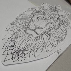 two sheets of paper with designs on them, one has a lion's head and the other has a flower in its hair