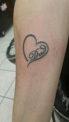 a heart tattoo with the word love written in cursive font on the arm