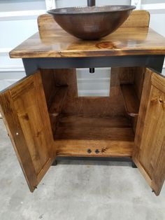 a bathroom sink sitting on top of a wooden cabinet