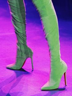 a woman's legs in high heel boots on stage