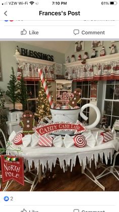 a table that has some candy canes on it and christmas decorations in the background