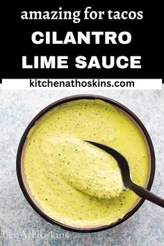 a bowl filled with lime sauce on top of a counter next to a black spoon