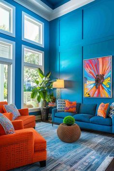 a living room with blue walls and orange furniture