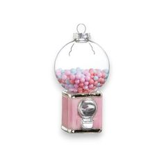 a pink and white gummy machine with lots of candy in it's top