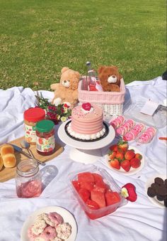 a picnic table with food and teddy bears on it