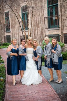 the bride and her bridesmaids pose for a photo