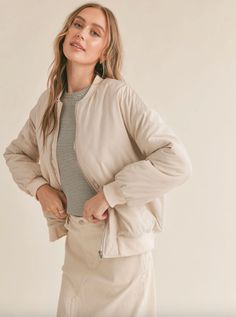 This cream bomber jacket by Sadie & Sage is everything! Crafted from a premium blend of nylon and polyester, this jacket combines style and functionality seamlessly. The zip-up closure and side pockets give a modern edge, while the padded design ensures warmth without compromising style. Good outerwear is always worth the investment. Brand: Sadie & Sage 57% Nylon, 43% Polyester Classic fit True to size Model is wearing a size small Cream Nylon Outerwear For Spring, Spring Cream Nylon Outerwear, Cream Nylon Outerwear For Fall, Everyday Spring Nylon Outerwear, Chic Beige Outerwear With Ribbed Cuffs, Cream Puffer Jacket With Pockets For Spring, Cream Puffer Jacket For Spring, Cream Outerwear With Ribbed Cuffs For Spring, Spring Cream Outerwear With Ribbed Cuffs