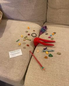 scissors and other items are scattered on the couch's back cushion, which has been left over