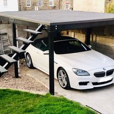 a white car parked under a covered parking lot