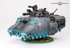 a grey and blue warhammer tank on a white background