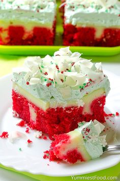 a slice of red velvet cake with white frosting and sprinkles on a plate