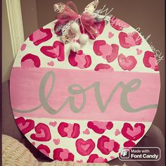 a pink and white painted sign with hearts on it that says love made with font candy