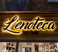 a store front with the word lenoteco lit up at night