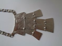 "Huge Showy Silver Toned Metal Nugget Hammered Abstract Design Articulated Segments Square Box Chain Drape Pendant Runway Necklace Fabulous! Unsigned Vintage Beautiful Circa 80's/90's Huge Silver Toned Metal Nugget Hammered Abstract Design Articulated Segments Drape Center Pendant Runway Necklace Egyptian Style Jewelry! The necklace is in Excellent vintage condition with very little signs of wear on the backside but the front is fabulous the silver tone color/finish is so bright and shine very c Runway Necklace, Brutalist Design, Egyptian Style, Bib Necklaces, Gold Chain Jewelry, Monogram Design, Chain Link Necklace, Box Chain, Style Jewelry